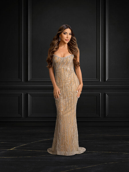 Taleen Marie, of The Real Housewives of Dubai, in a floor length gold and jeweled gown.