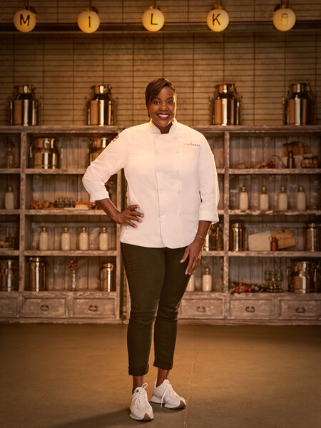 Full length of Michelle Wallace in her chef's uniform in a kitchen pantry
