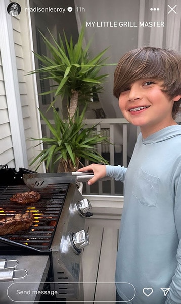 Hudson Hughes smiling and grilling in his backyard.