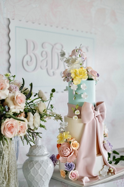 Detail shot of floral bouquets and a baby shower cake at Nicole Martin's baby shower.