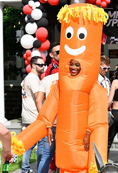 Ciara Miller smiling in an inflatable costume at a raceway themed party.