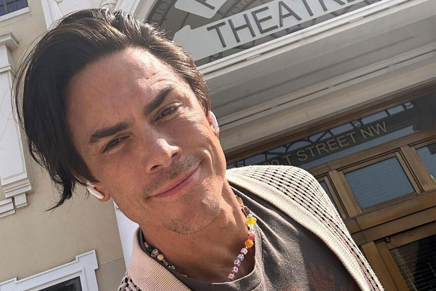Tom Sandoval posing in front of a theater.