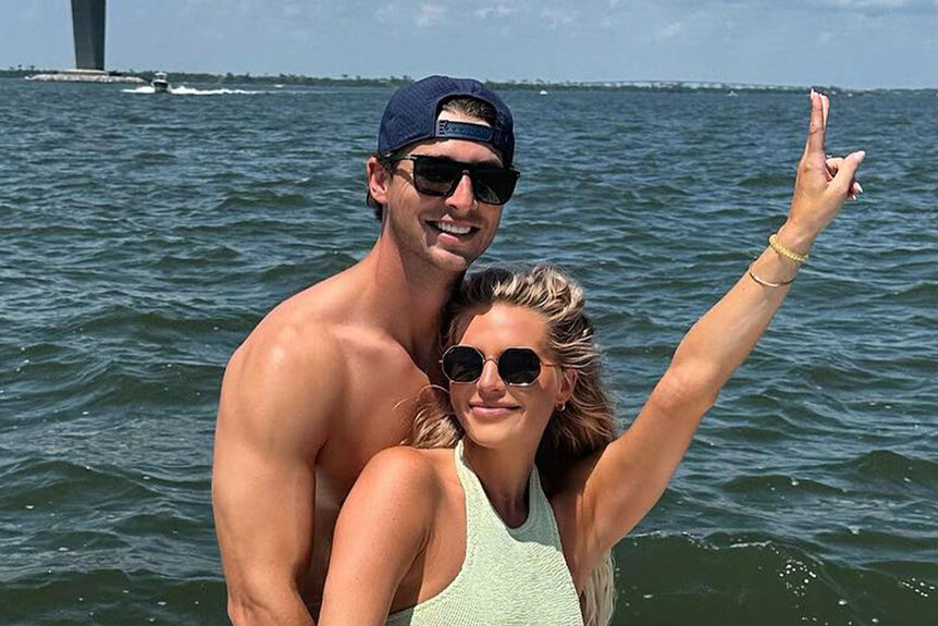 Madison LeCroy and Brett Randle posing and smiling together on a boat.