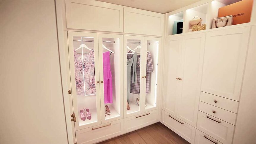 Madison LeCroy's closet with white cabinets and doors with glass panels.