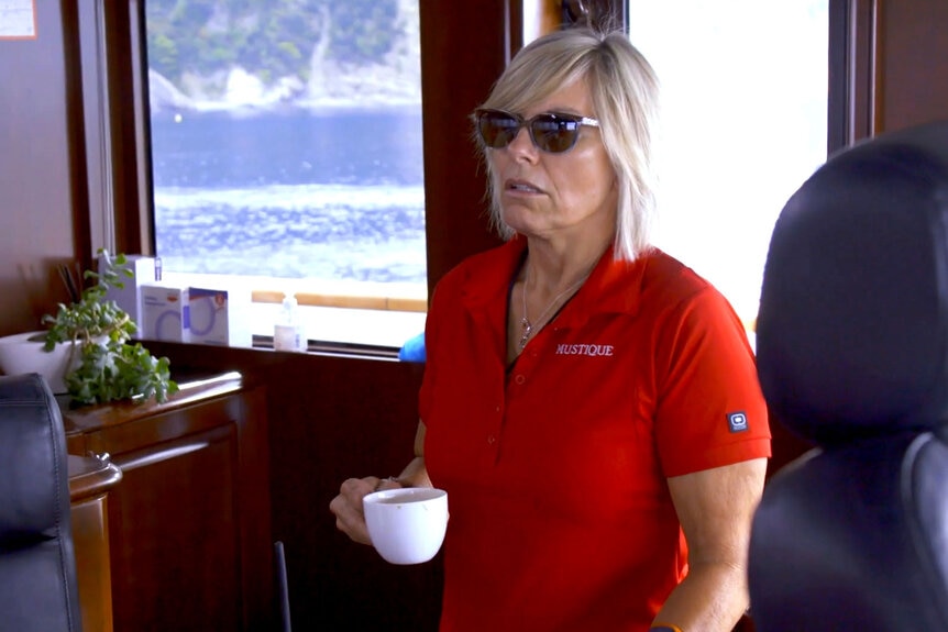 Captain Sandy having a conversation with a crew member on Below Deck