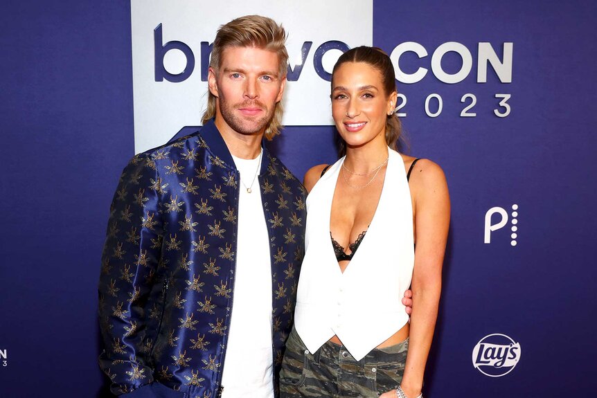 Kyle Cooke and Amanda Batula smiling and posing together while walking the red carpet for BravoCon 2023.