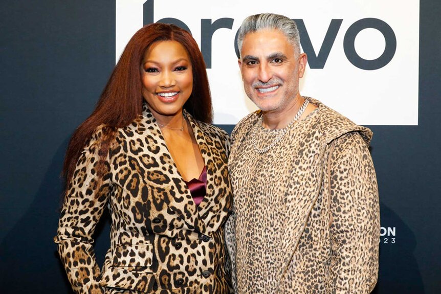 Garcelle Beauvais and Reza Farahan smiling and posing together during BravoCon 2023.
