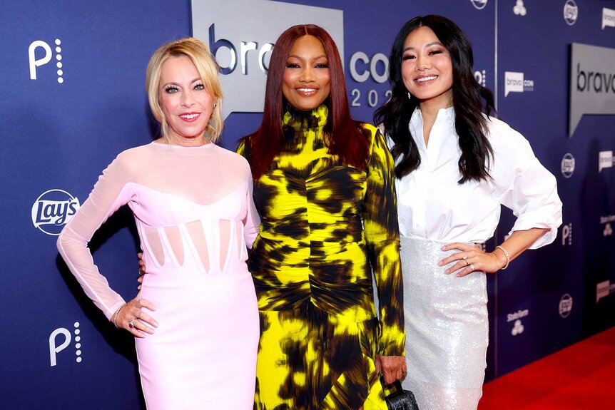 Sutton Stracke, Garcelle Beauvais, and Crystal Kung Minkoff posing together while walking the red carpet for BravoCon 2023.