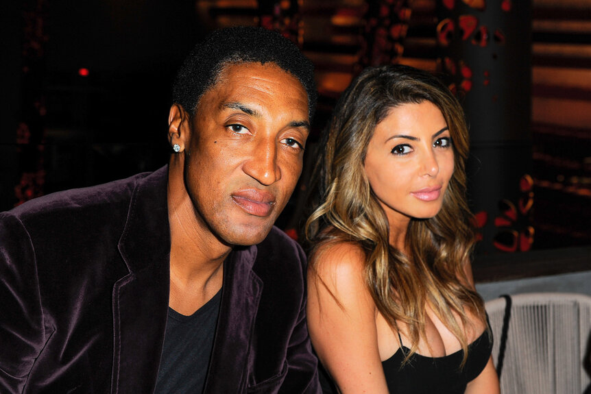 Scottie Pippen wears a velvet jacket and poses with Larsa Pippen, who wears a black dress.