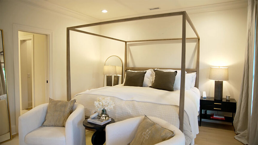 Madison LeCroy's white bedroom with a canopy bed frame.