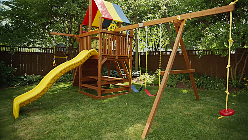 Ashley Darby's home playground with a swing set and a slide.