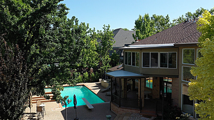 Heather Gay's home backyard featuring a pool with a diving board.