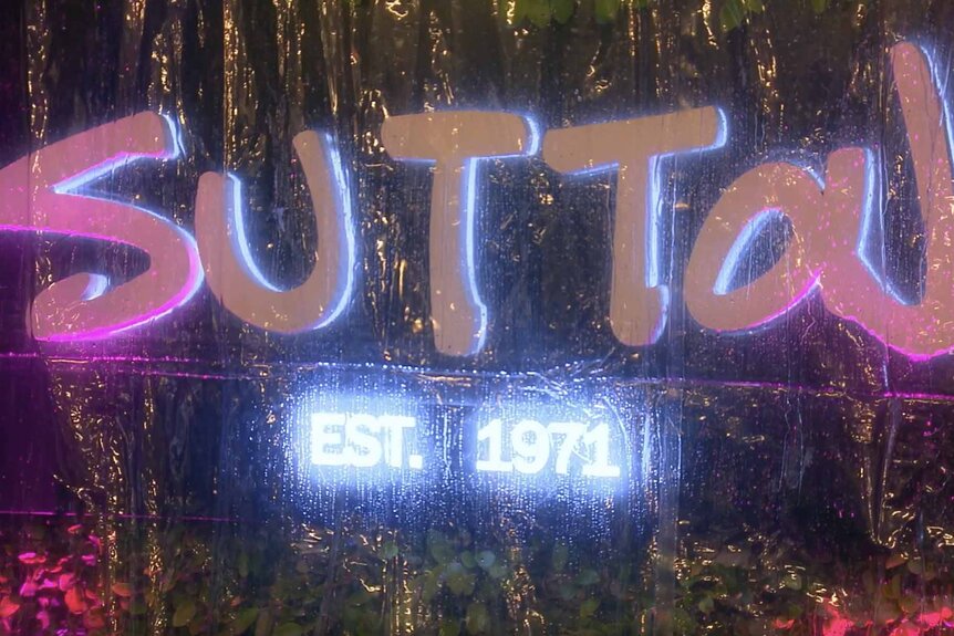 A neon sign that says "Sutton" shines in The Real Housewives of Beverly Hills Season 13 Episode 8.