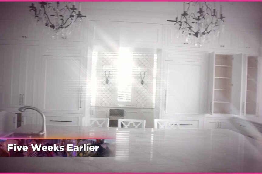 Nicole Martin's bright white kitchen with two chandeliers before renovation.