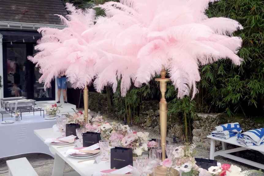 Pink table decorations, towels, and food appear at Marysol Patton's party.