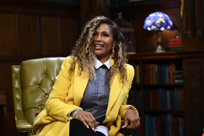 Sheree Whitfield sitting in a libary on the Traitors Season 2
