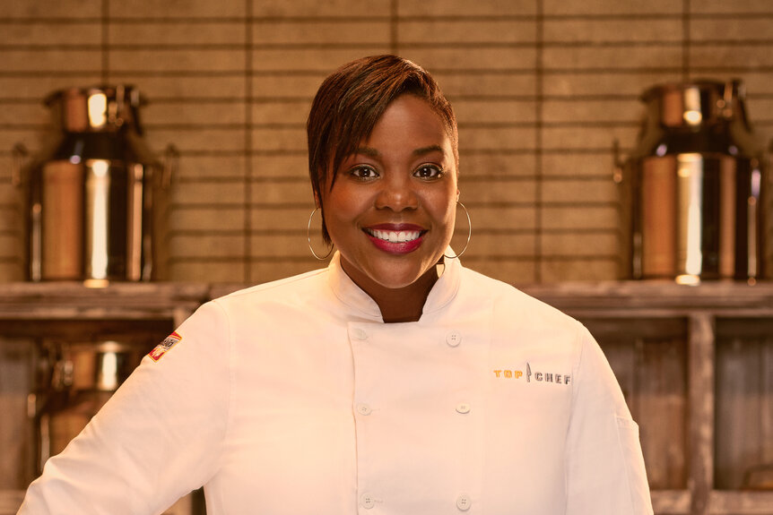 Michelle Wallace wearing a chef's uniform in a kitchen pantry