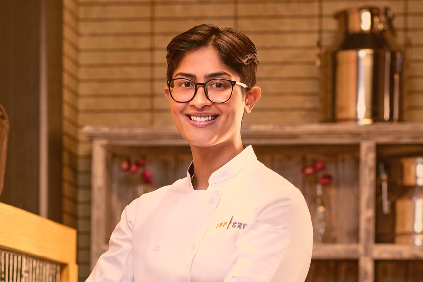 Rasika Venkatesa wearing a chef's uniform in a kitchen pantry
