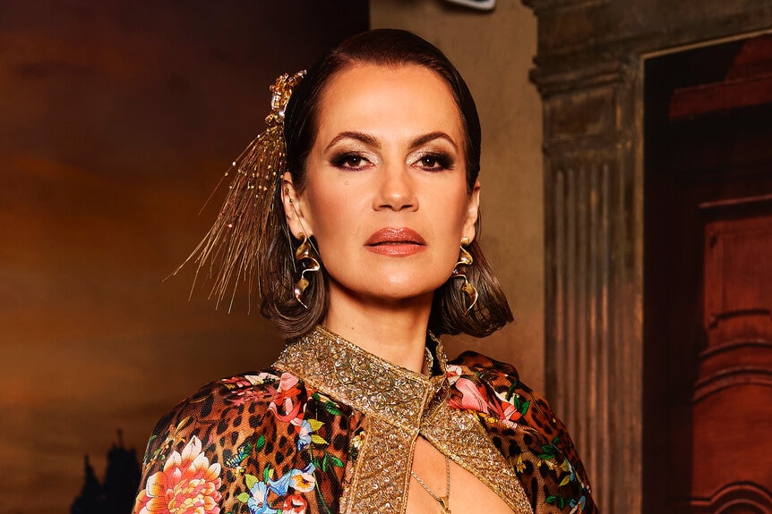 Julia Lemigova wears a patterned cape in front of a Mexico City inspired set.