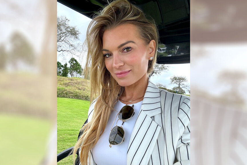 Lindsay Hubbard wearing a striped black and white blazer on a golf course.
