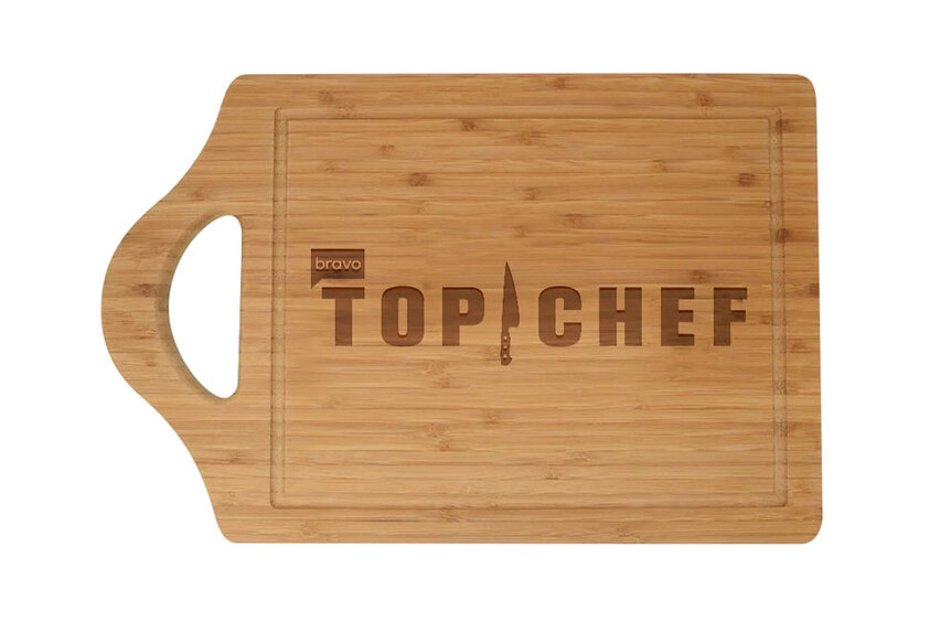 Cutting board with the words "Top Chef" inscribed on it.