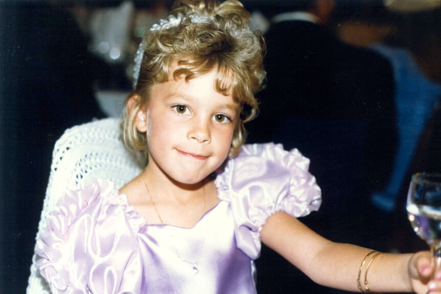 Lisa Hochstein as a young child in a formal dress.