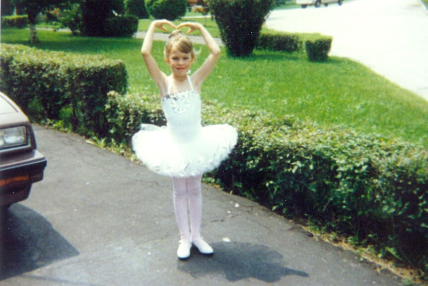 Lisa Hochstein dressed as a ballerina posing in a driveway.
