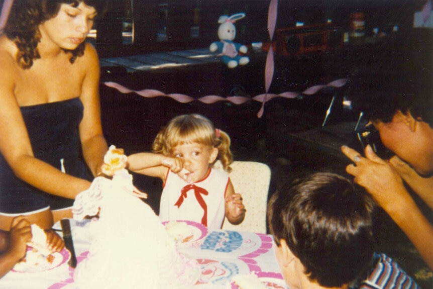 Lisa Hochstein as a child eating birthday cake.