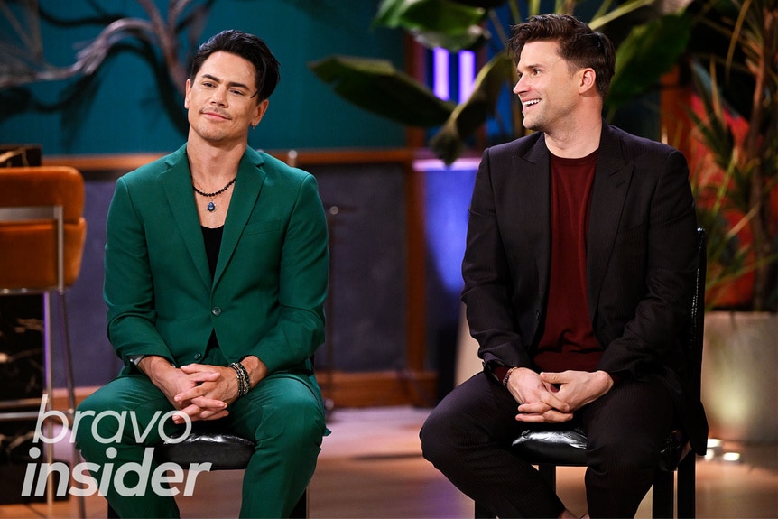 Tom Sandoval and Tom Schwartz smiling and laughing at the Vanderpump Rules Season 11 Reunion set.