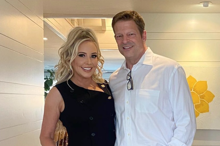 Shannon Storms Beador wearing a black dress and John Janssen wearing a white shirt at Shannon's home.