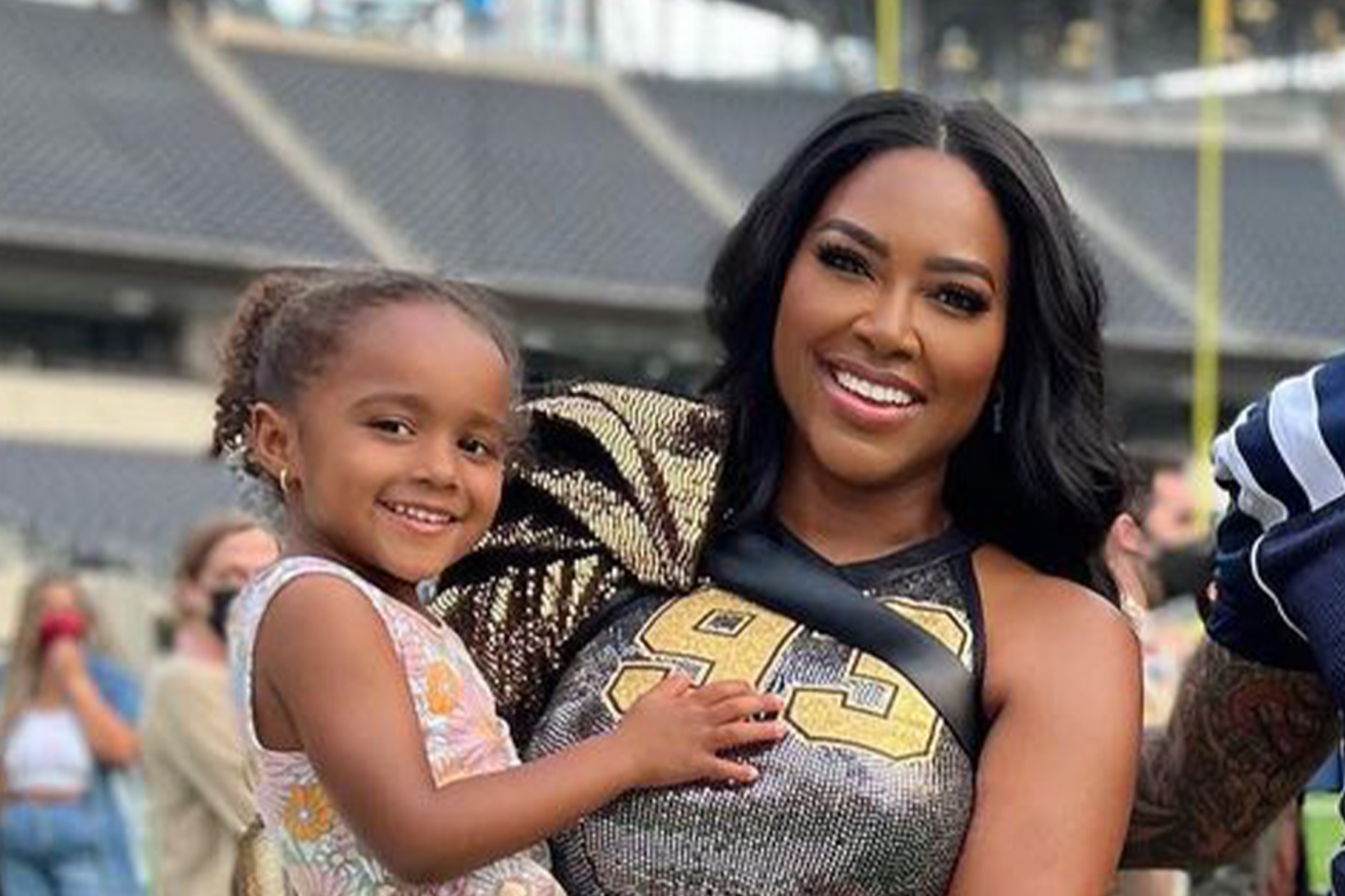 Kenya Moore and Brooklyn Daly in football stadium together.