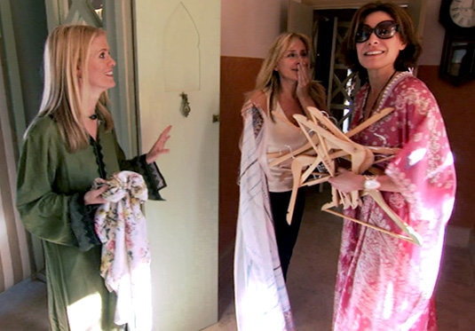 Luann De Lesseps holding many hangers while filming Real Housewives of New York