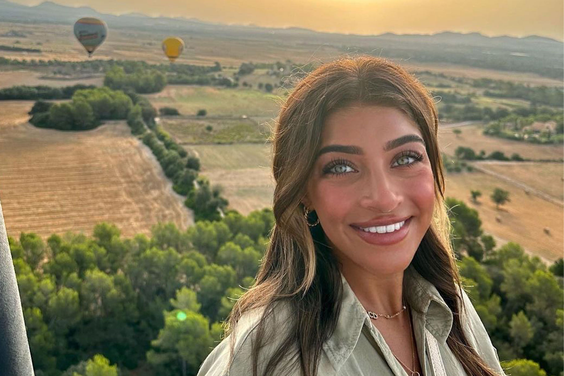 Gia Giudice smiling in a hot air balloon in Spain.