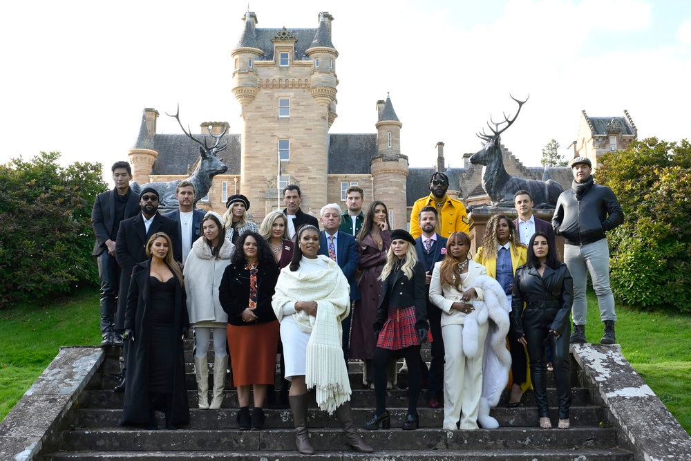 The Cast of The Traitors Season 2 in front of a castle.