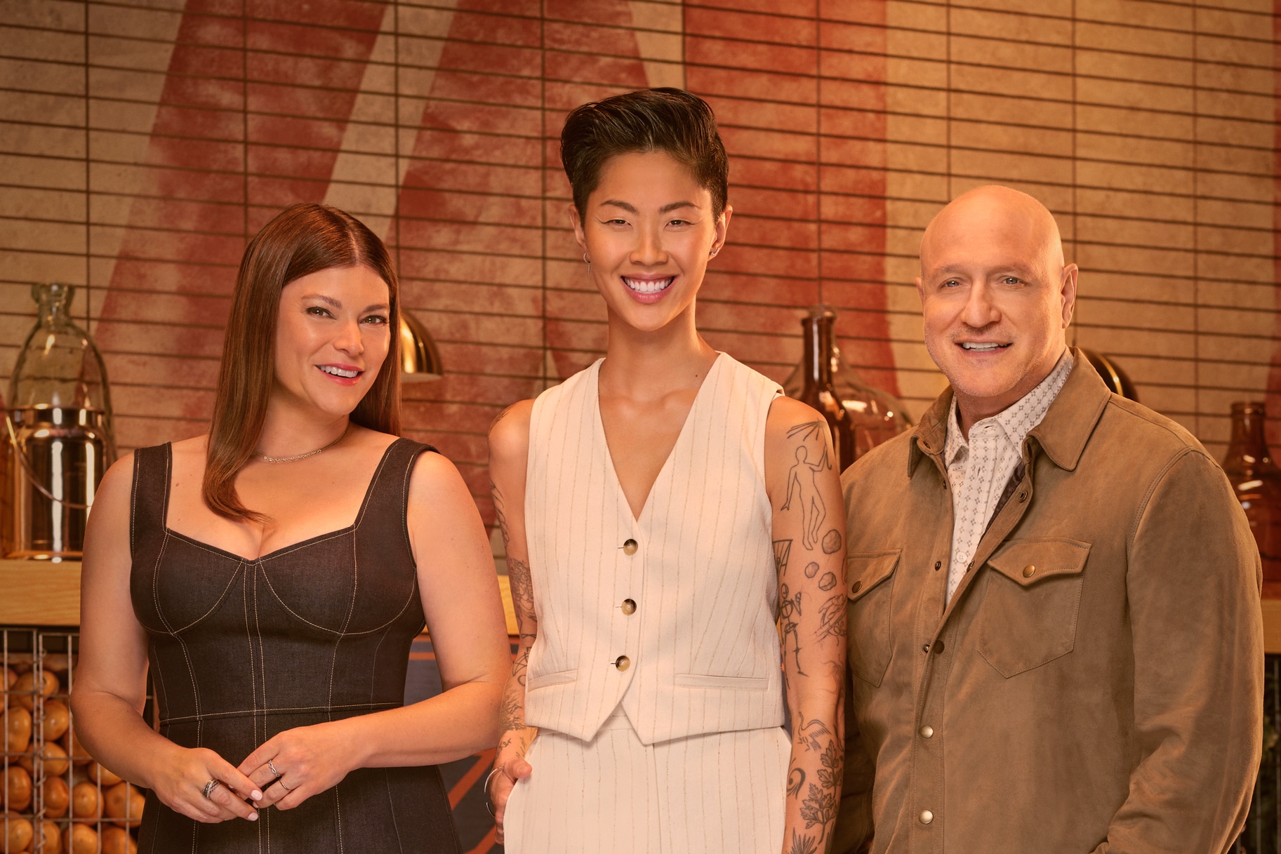 Gail Simmons, Kristen Kish, and Tom Colicchio in a kitchen pantry together