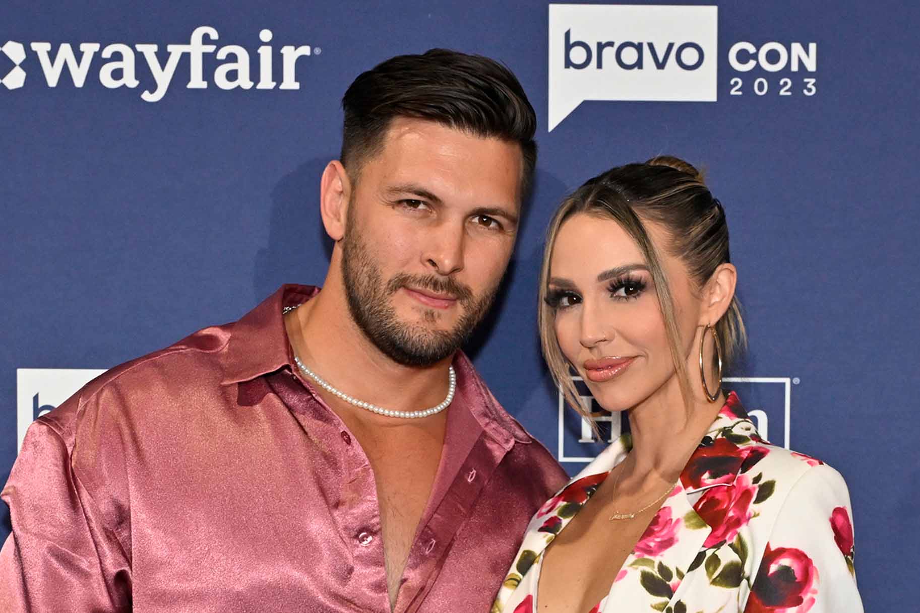 Brock Davies and Scheana Shay pose in coordinating pink outfits.
