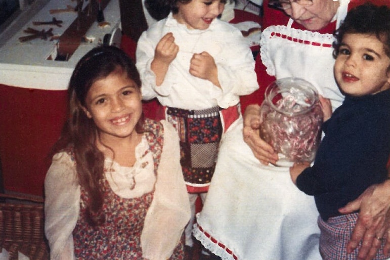 Dolores Catania smiling with friends as a small child.