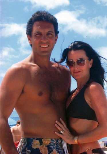 Kyle Richards with her husband, Mauricio Umansky, while wearing a bathing suit at the beach.