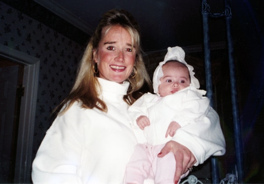 Kim Richards holding a baby girl.