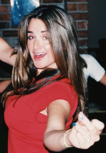 Kyle Richards wearing a red top having fun at a party.