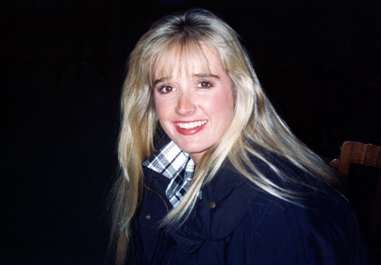 Kim Richards smiling as a young woman.