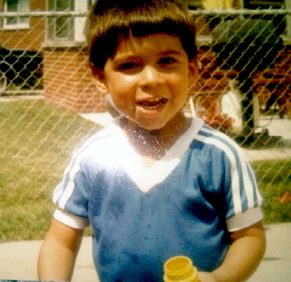Jax Taylor as a young boy smiling.