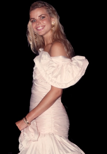 Alexia Nepola as a young woman smiling wearing a light pink off the shoulder dress