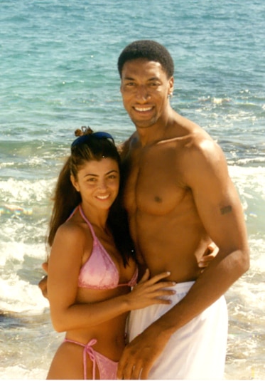 Larsa Pippen posing at the beach in a pink bikini with Scottie Pippen.