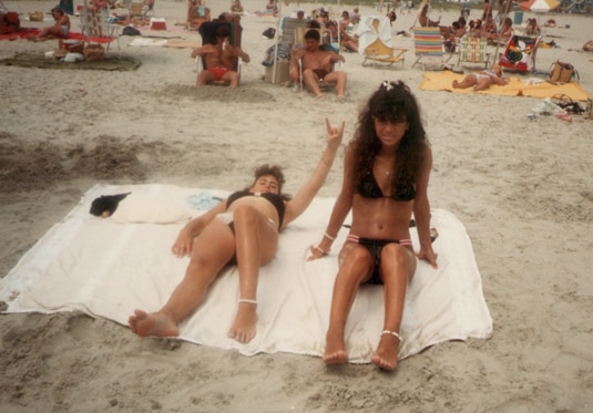 Teresa Giudice on the beach in a bikini with a friend