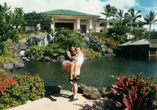 Joe Giudice holding up Teresa Giudice in front of a pond and garden
