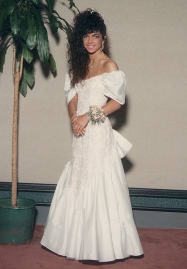 Teresa Giudice wearing an off the shoulder white gown and a corsage