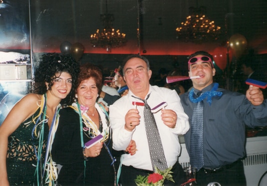 Teresa Giudice with her parents and brother Joe Gorga celebrating at a party