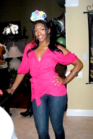 Porsha Williams wearing a pink top and jeans on her birthday.