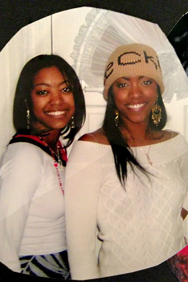 Porsha Williams standing next to her sister, Lauren Williams, while both of them wear white tops.